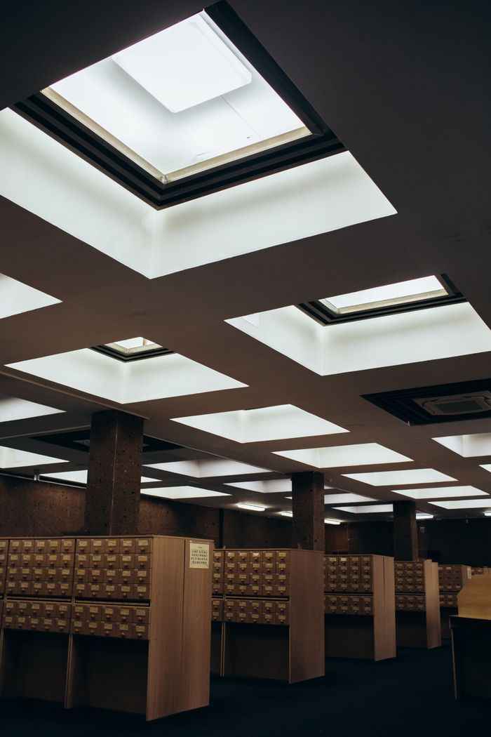 A stylish library interior with card catalogs and bright skylights.
