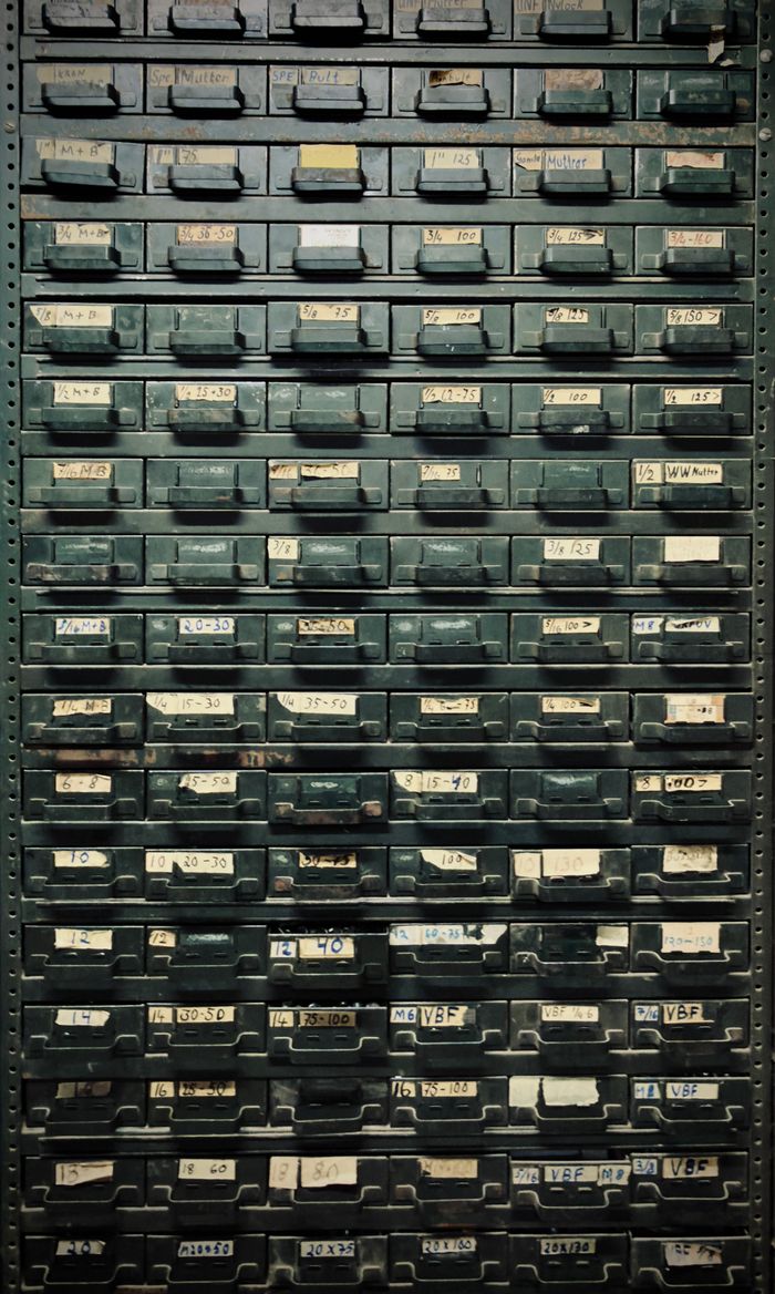 A vintage metal cabinet with labeled drawers, ideal for industrial-themed decor.