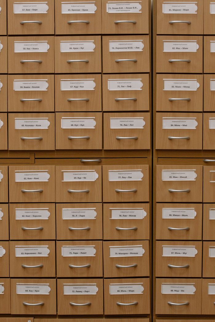 Vertical shot of labeled wooden file drawers for efficient organization